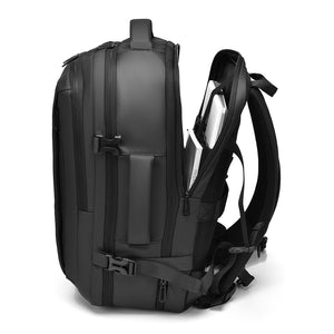 Grey travel backpack side zip opened to show quick-access laptop compartment