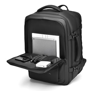 Grey backpack front pocket folded down with laptop, tablet and accessories organiser