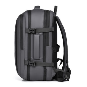Side view of the grey 40L backpack showing compression straps and side handle