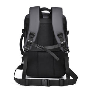 Back panel of the grey travel backpack with padded shoulder straps and luggage strap