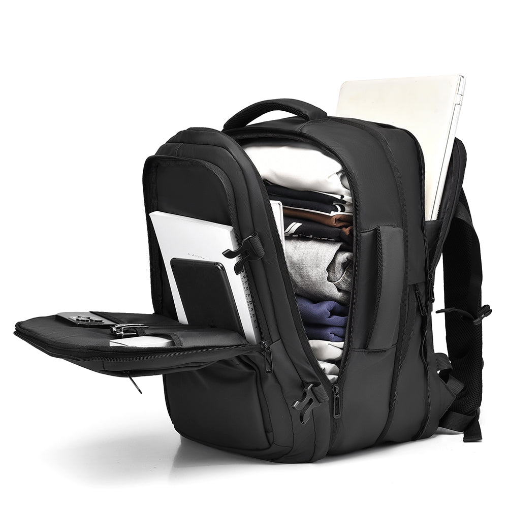 Grey travel backpack opened with laptop, clothes and gadgets packed inside
