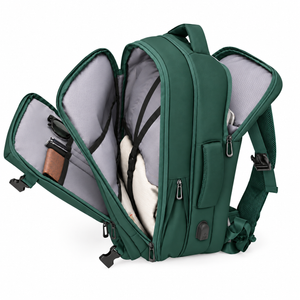 Green travel backpack opened to show laptop sleeve, inner compartments and USB port