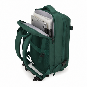 Laptop being placed into the padded sleeve of the green travel backpack