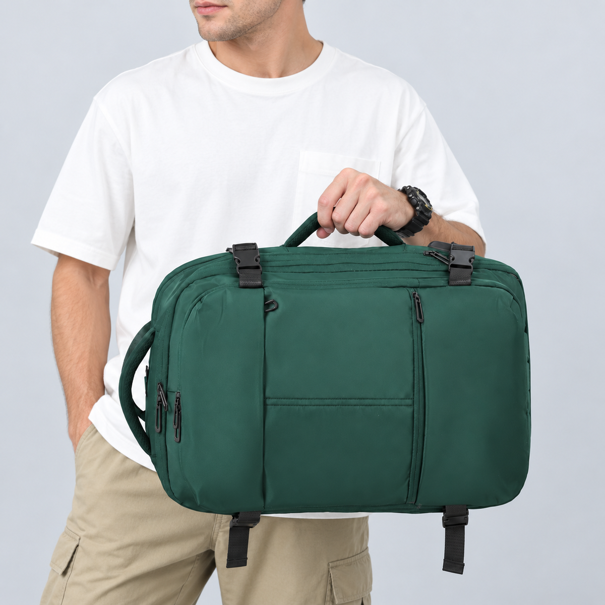 Man holding the green travel backpack horizontally by its side handle