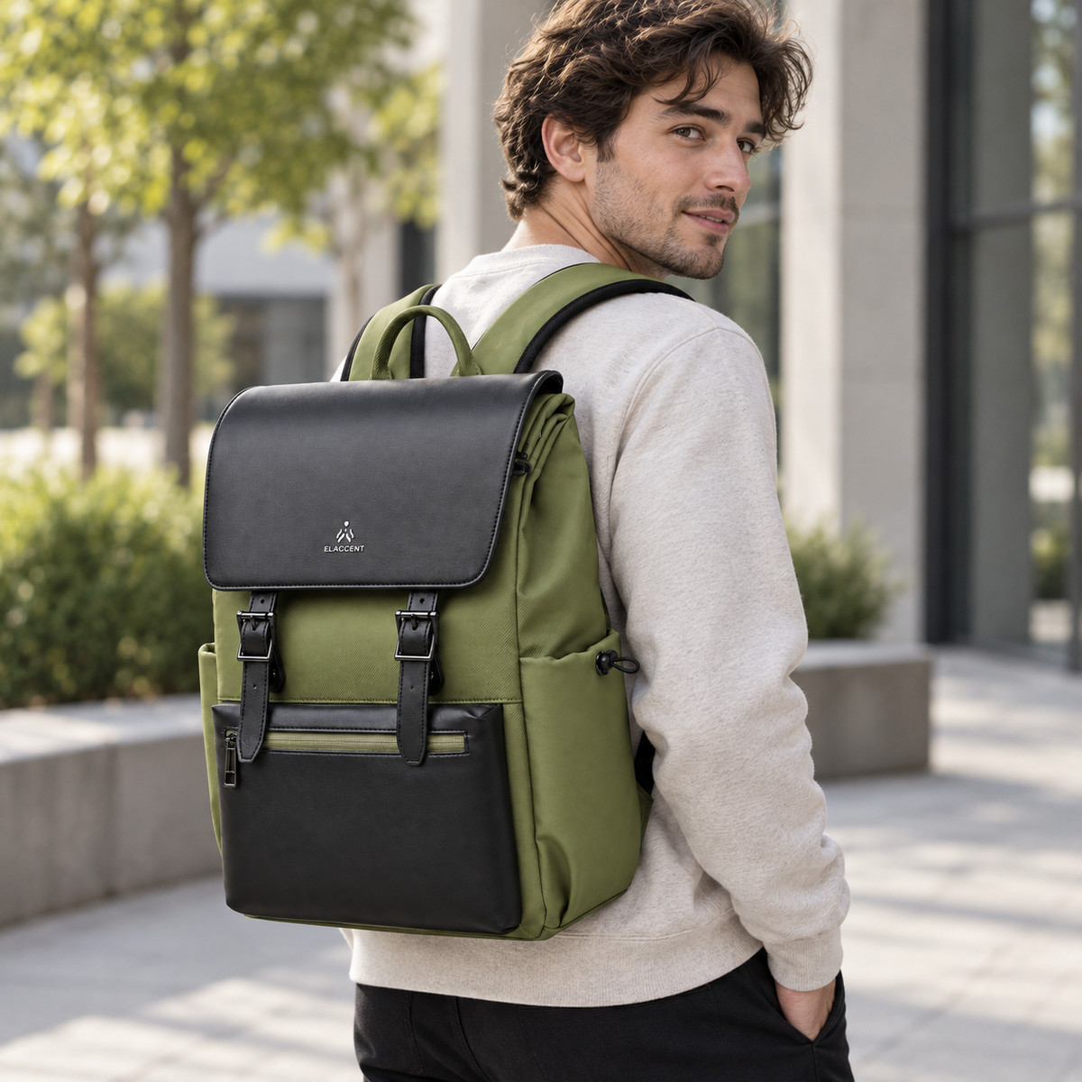 Man wearing the olive green and black magnetic flap laptop backpack outdoors